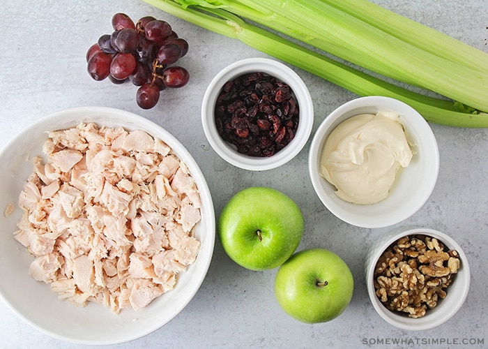 bowls of chicken grapes walnuts and apples