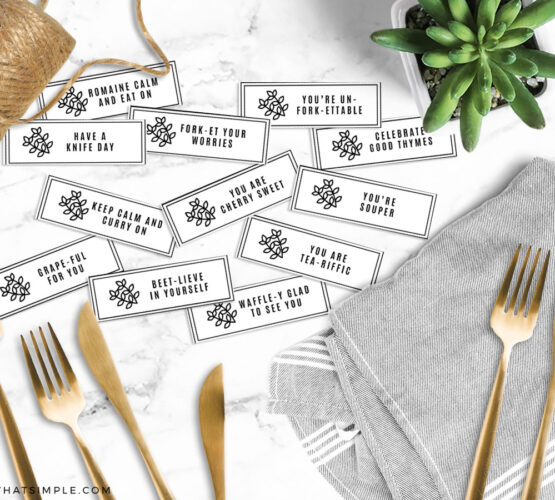 food pun utensil tags next to gold silverware