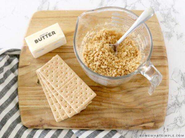 mixing graham crackers and melted butter