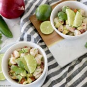 two small white bowls with avocado shrimp salad inside
