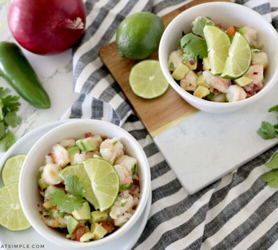 two small white bowls with avocado shrimp salad inside