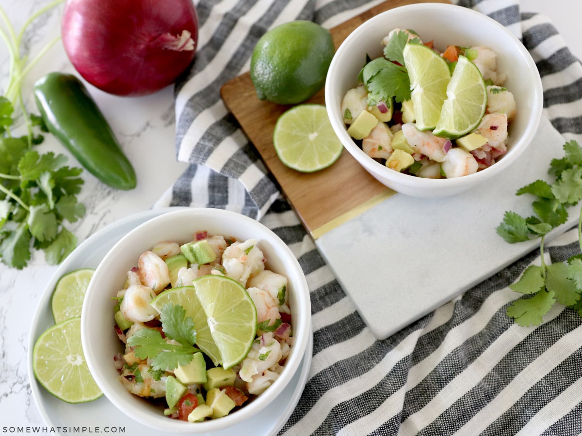 two small white bowls with avocado shrimp salad inside