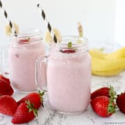 two glasses filled with strawberry banana smoothies