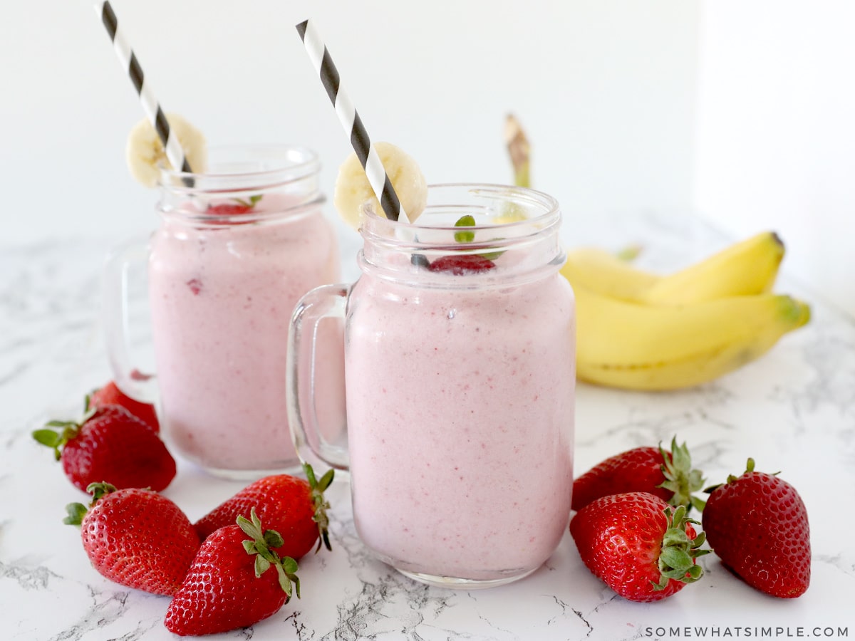 two glasses filled with strawberry banana smoothies