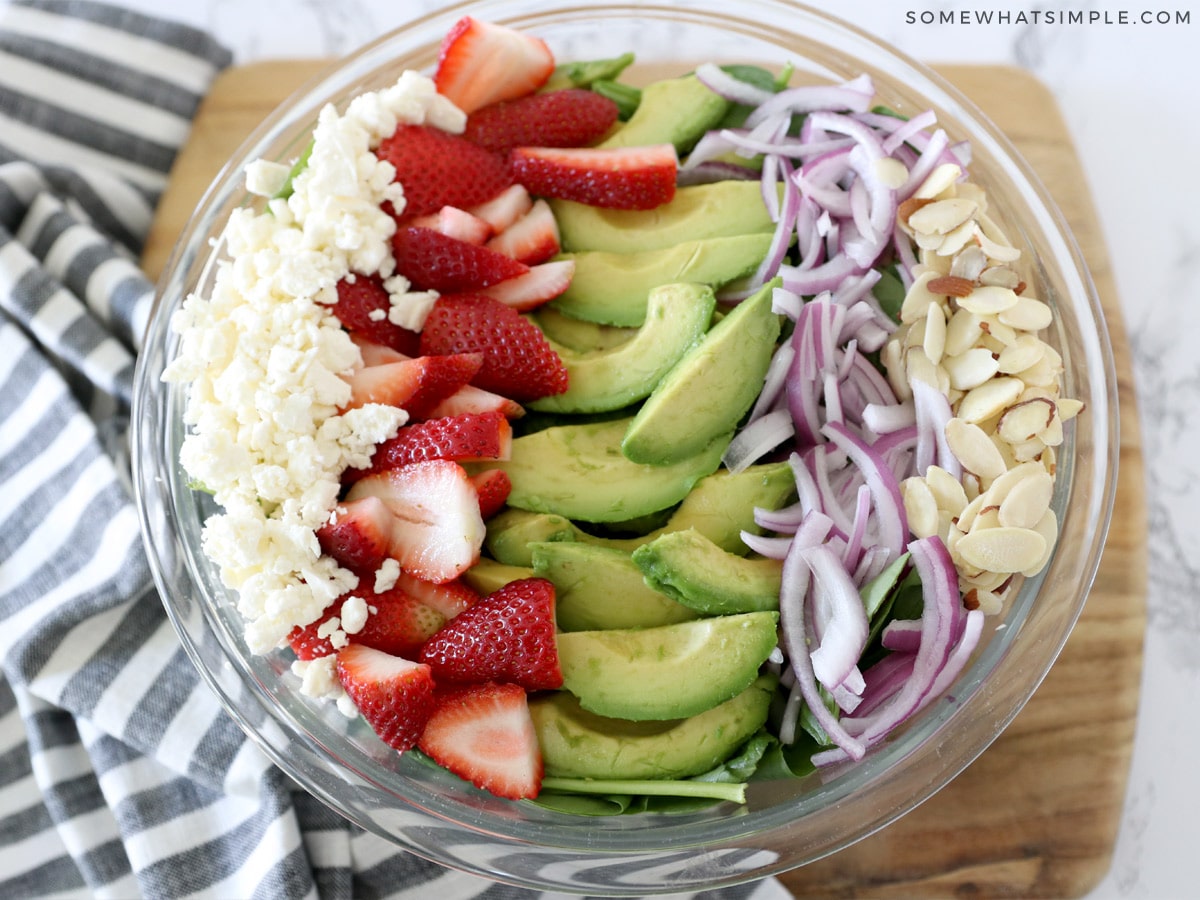 all the ingredients for a salad lined up in a bowl