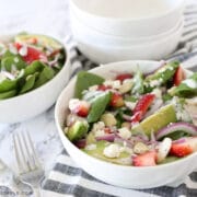 white bowl with strawberry spinach salad