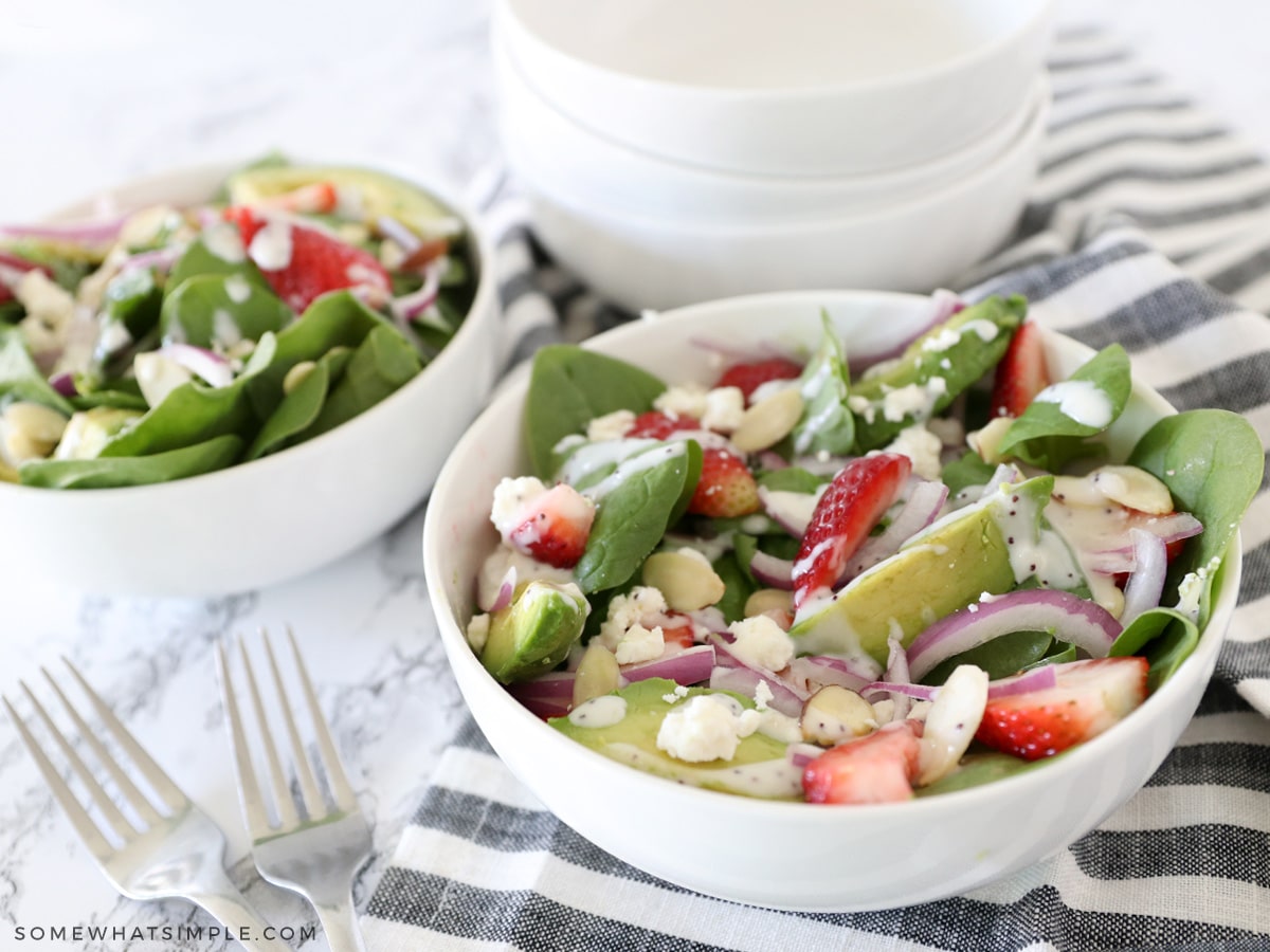 white bowl with strawberry spinach salad