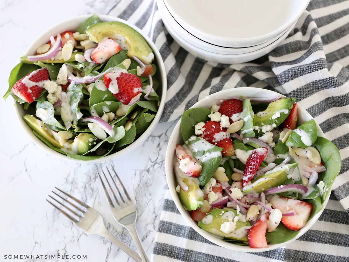 overhead shot of a strawberry spinach avocado salad