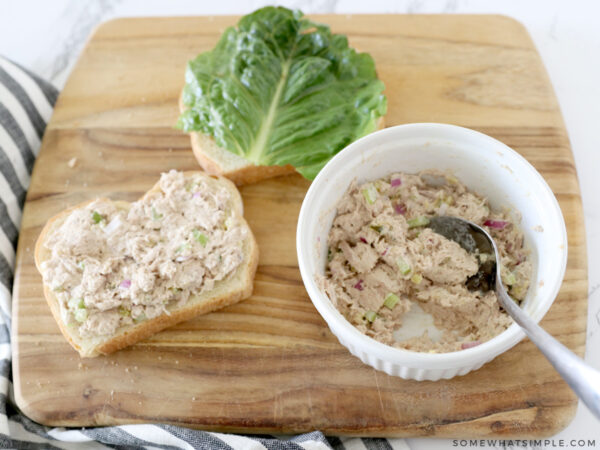sliced bread topped with lettuce and tuna salad