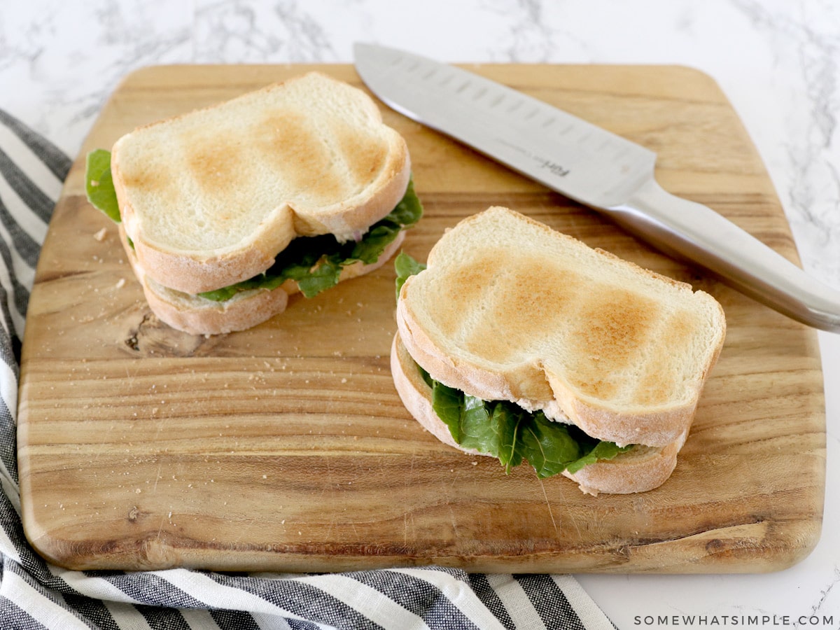 two tuna sandwiches on a cutting board