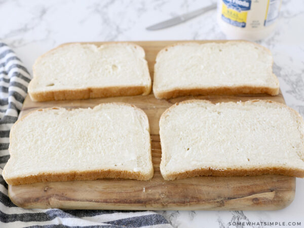 spreading mayo on slices of bread