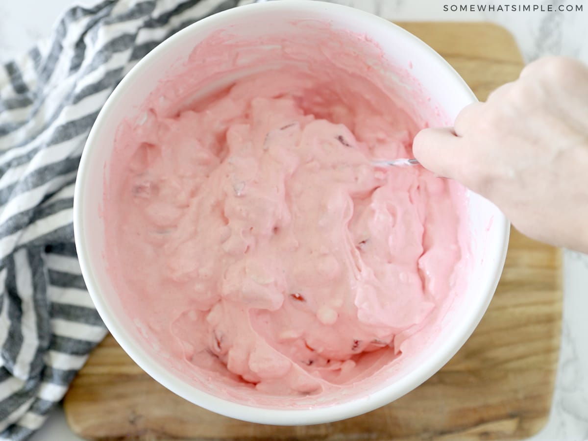 mixing all the ingredients in a white bowl