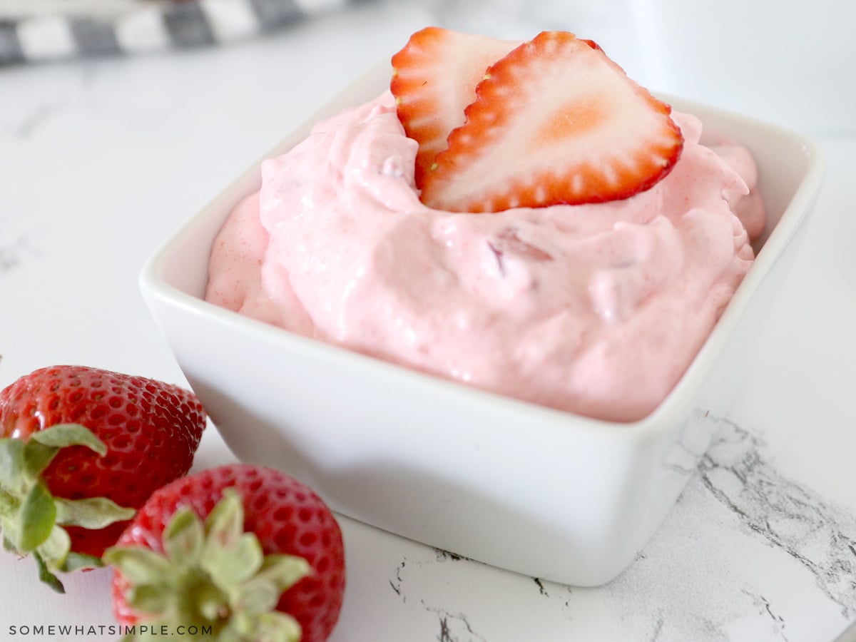 close up of a pink jello salad with strawberries