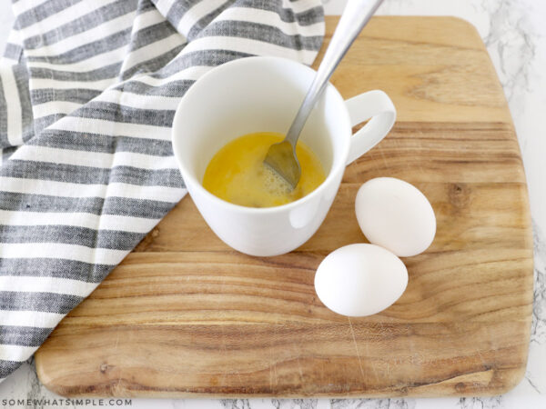 cracked eggs in a mug