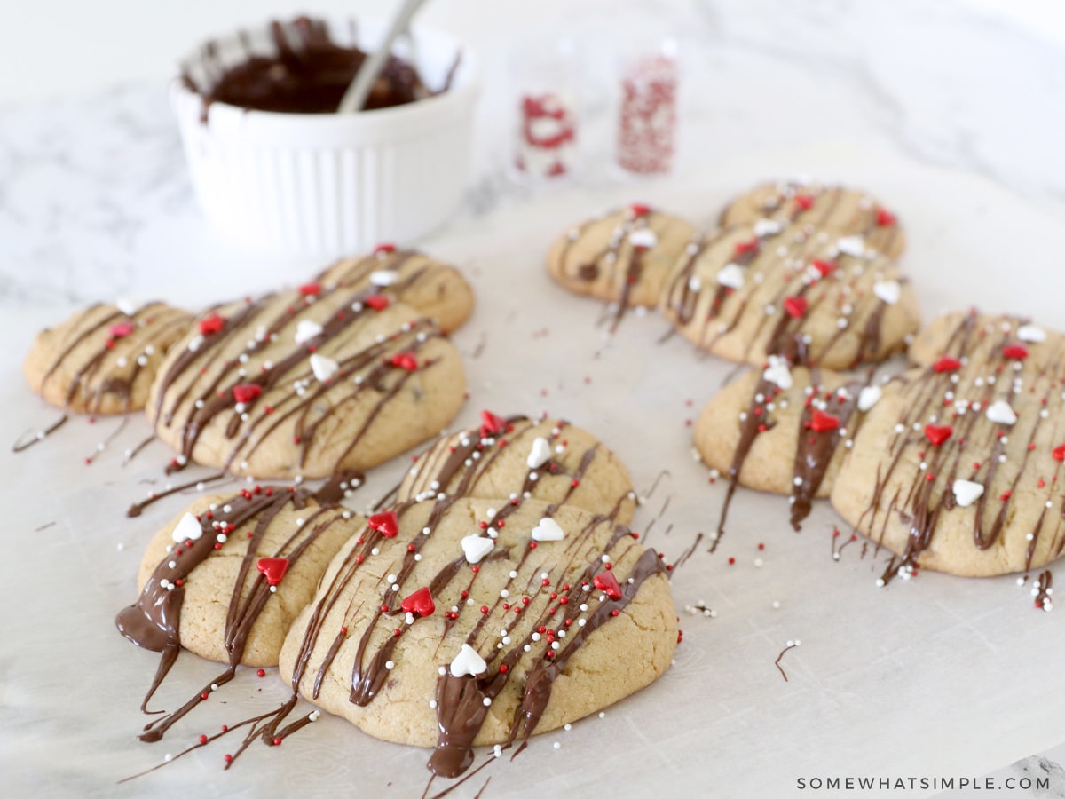 decorating cookies with chocolate drizzle and sprinkles