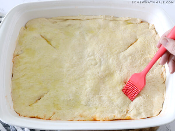 brushing dough with olive oil