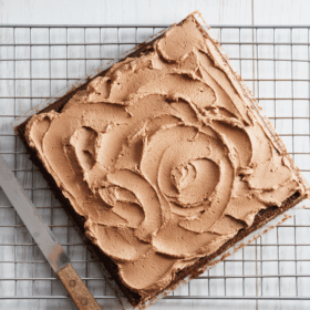 square chocolate cake on a cooling rack