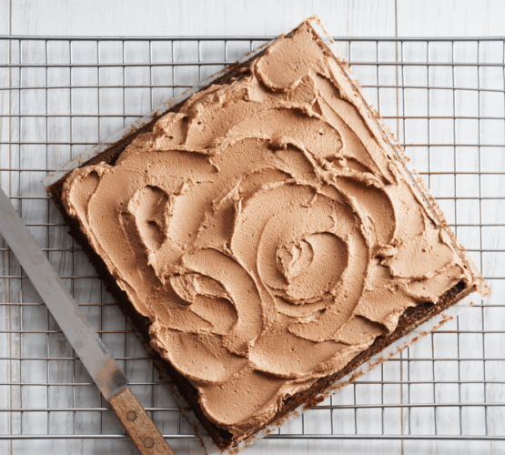 square chocolate cake on a cooling rack