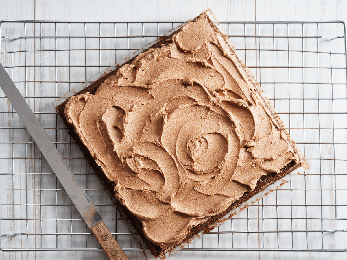 square chocolate cake on a cooling rack