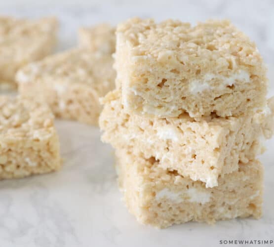 stack of brown butter rice krispy treats with more in the back ground