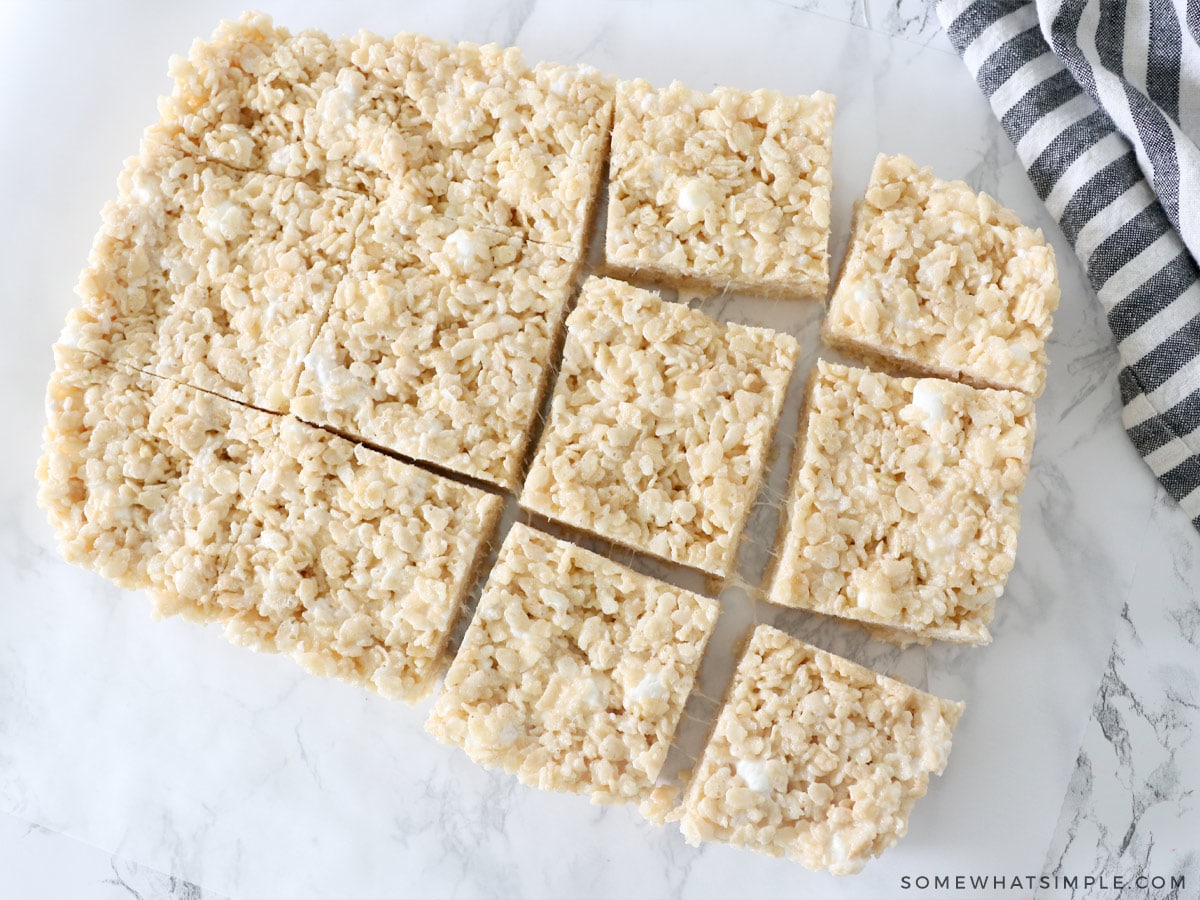 rice krispie treats cut into squares on a piece of parchment paper