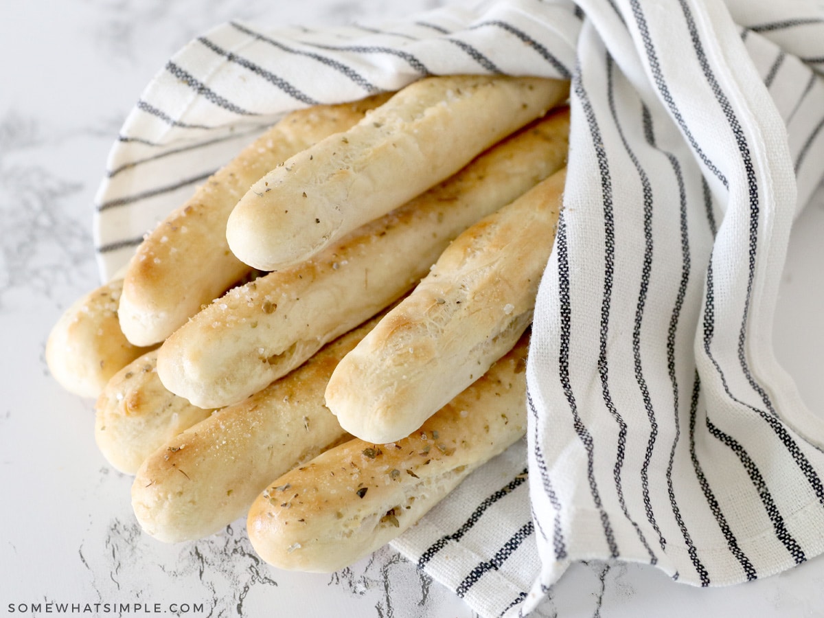stack of breadsticks wrapped in a cloth napkin