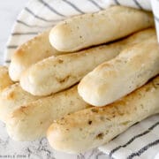 homemade breadsticks wrapped in a towel