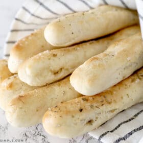 homemade breadsticks wrapped in a towel