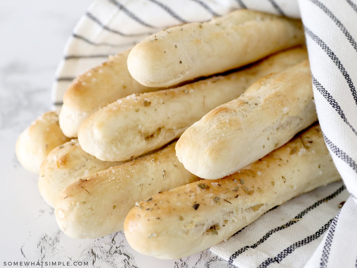 homemade breadsticks wrapped in a towel