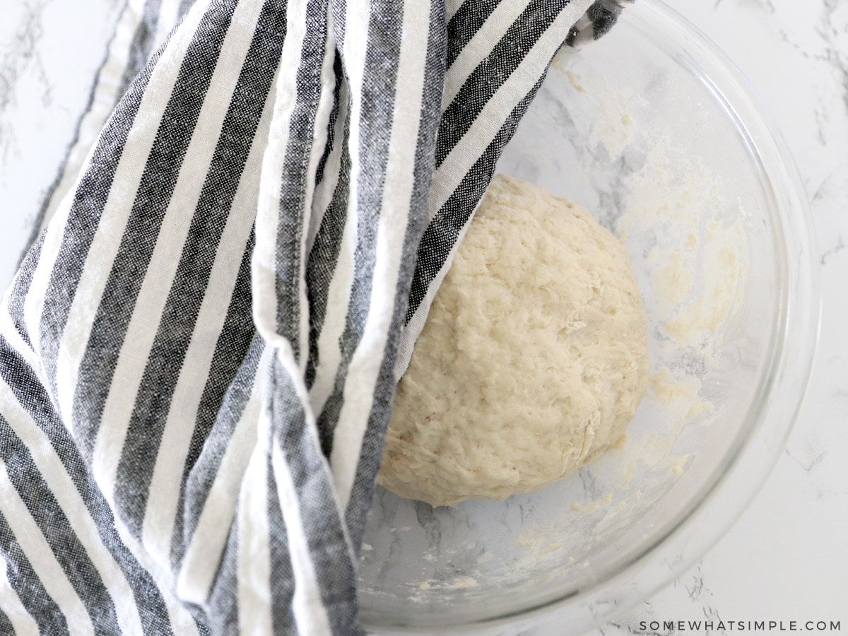 covering ball of dough with a towel