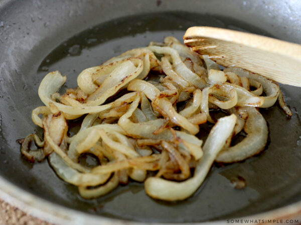 grilling onions for a pastrami sandwich