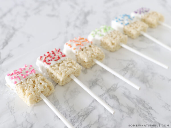 rainbow sprinkles on chocolate-dipped rice krispie treats