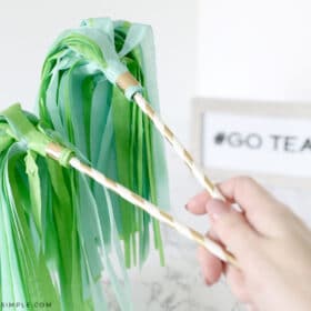 tissue paper pom poms attached to paper straws