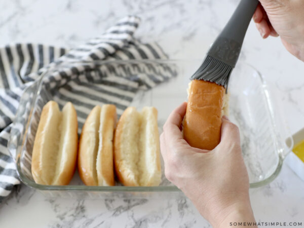 brushing buns with butter