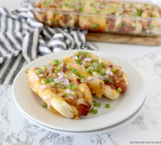 baked chili dogs served on a white plate