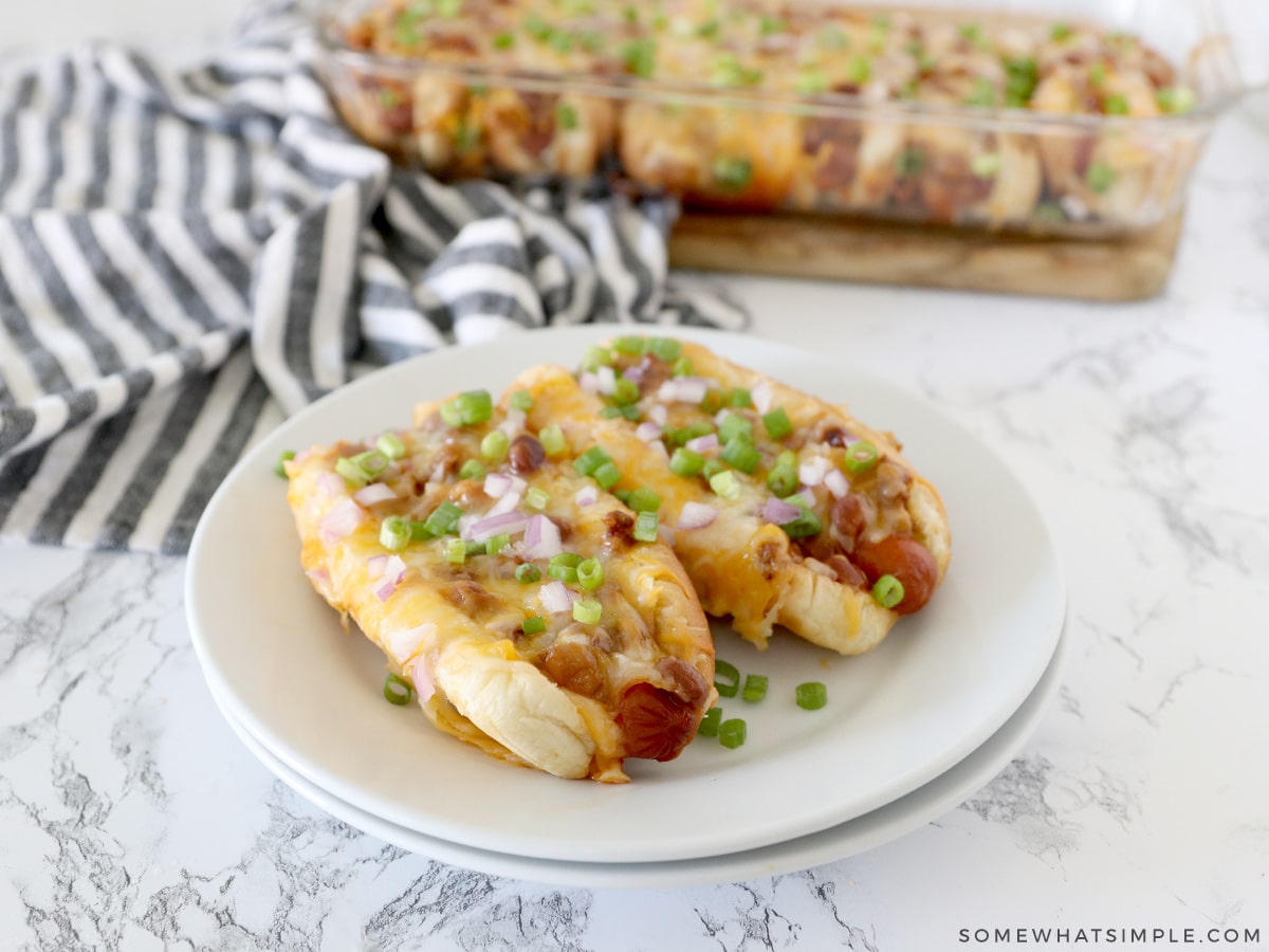 baked chili dogs served on a white plate