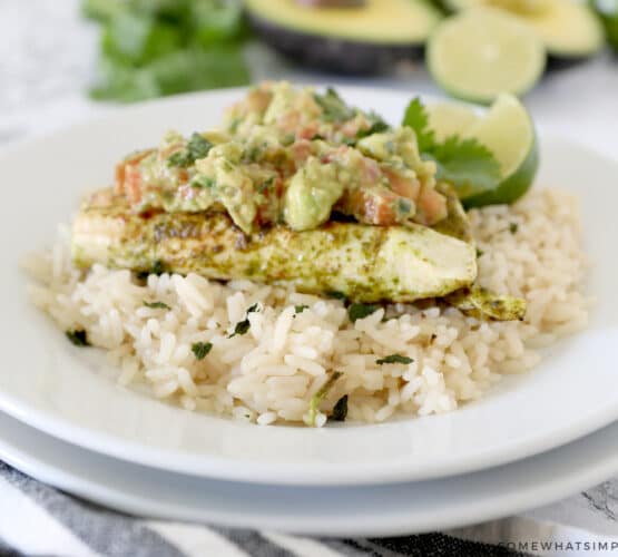 cilantro lime chicken on a bed of rice with avocado salsa on top
