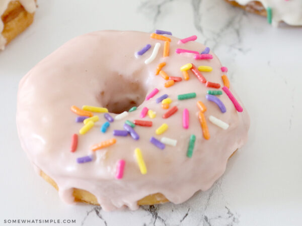 pink glazed donut with rainbow sprinkles