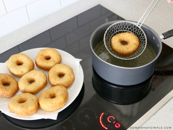 donut being browed in oil on the stove