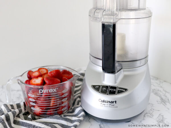 strawberries next to a food processor
