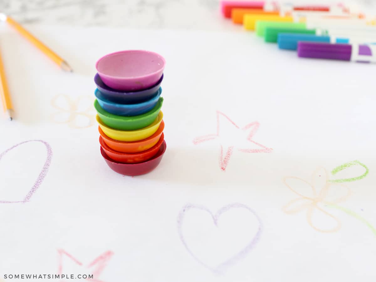 stack of crayons coloring on white paper