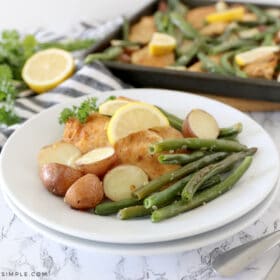 plated lemon parmesan chicken with the sheet pan in the back