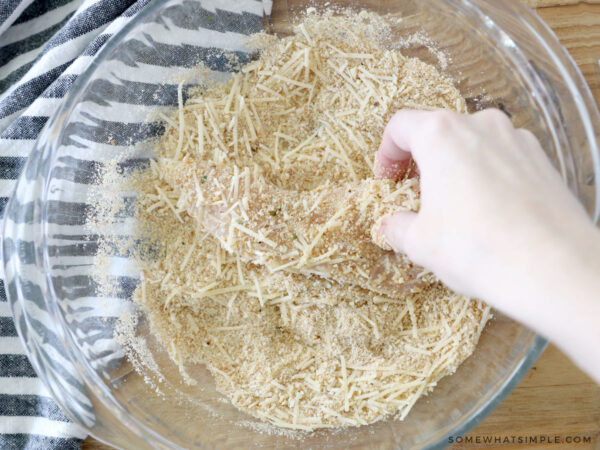 dipping chicken into a crumb coating