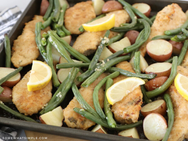 lemon slices on a sheet pan with chicken and vegetables