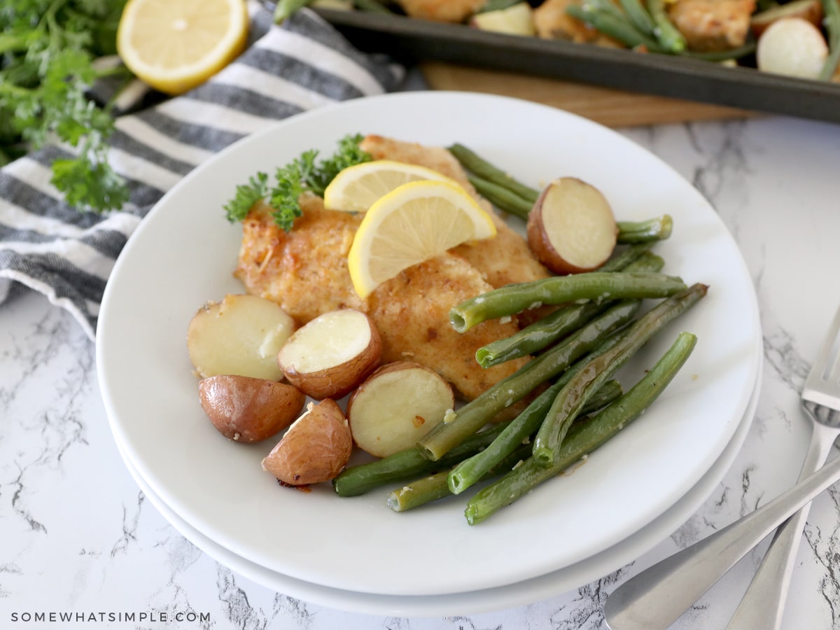 stacked plates with lemon parmesan chicken on top
