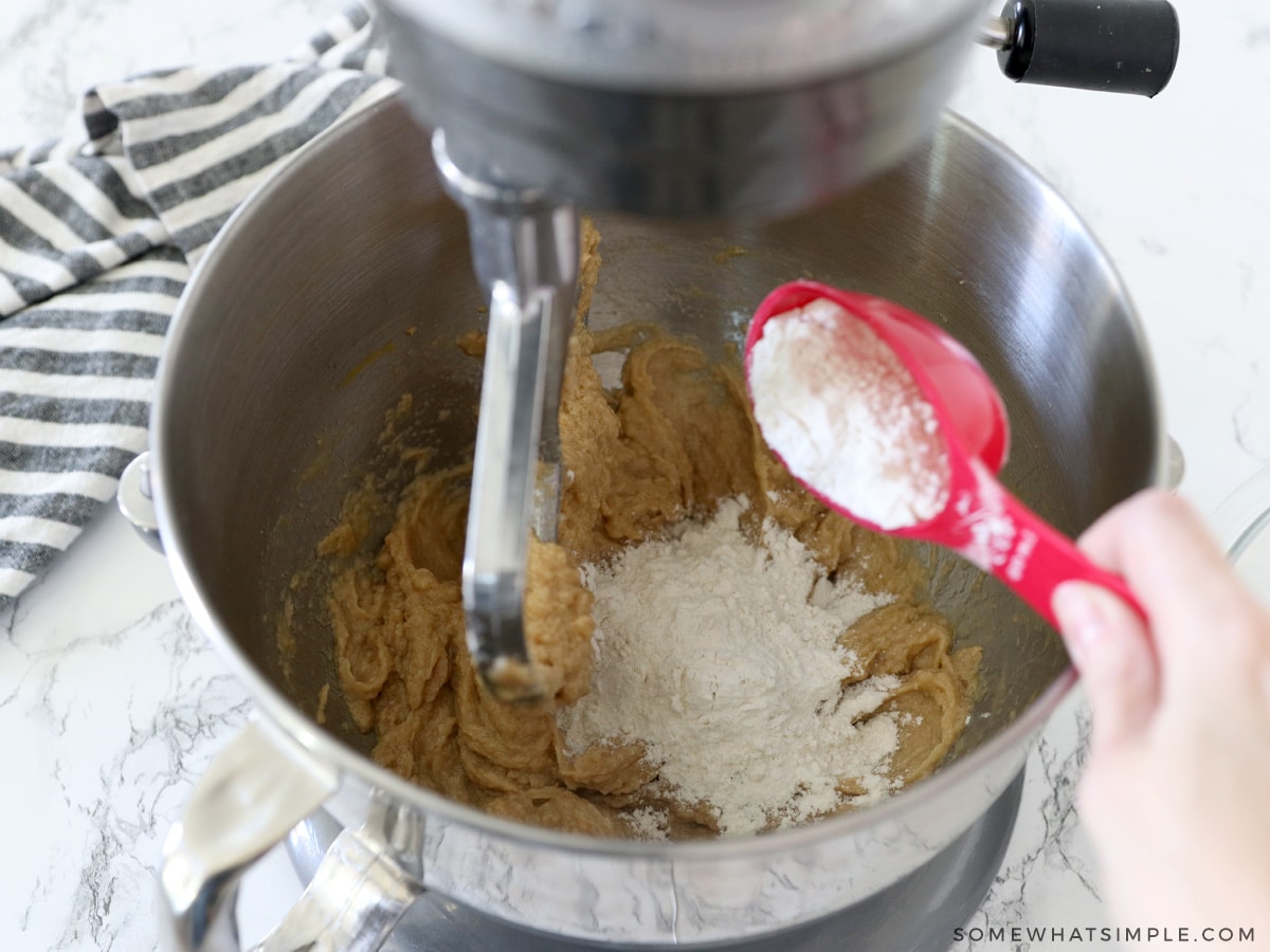 adding dry ingredients to cookie dough