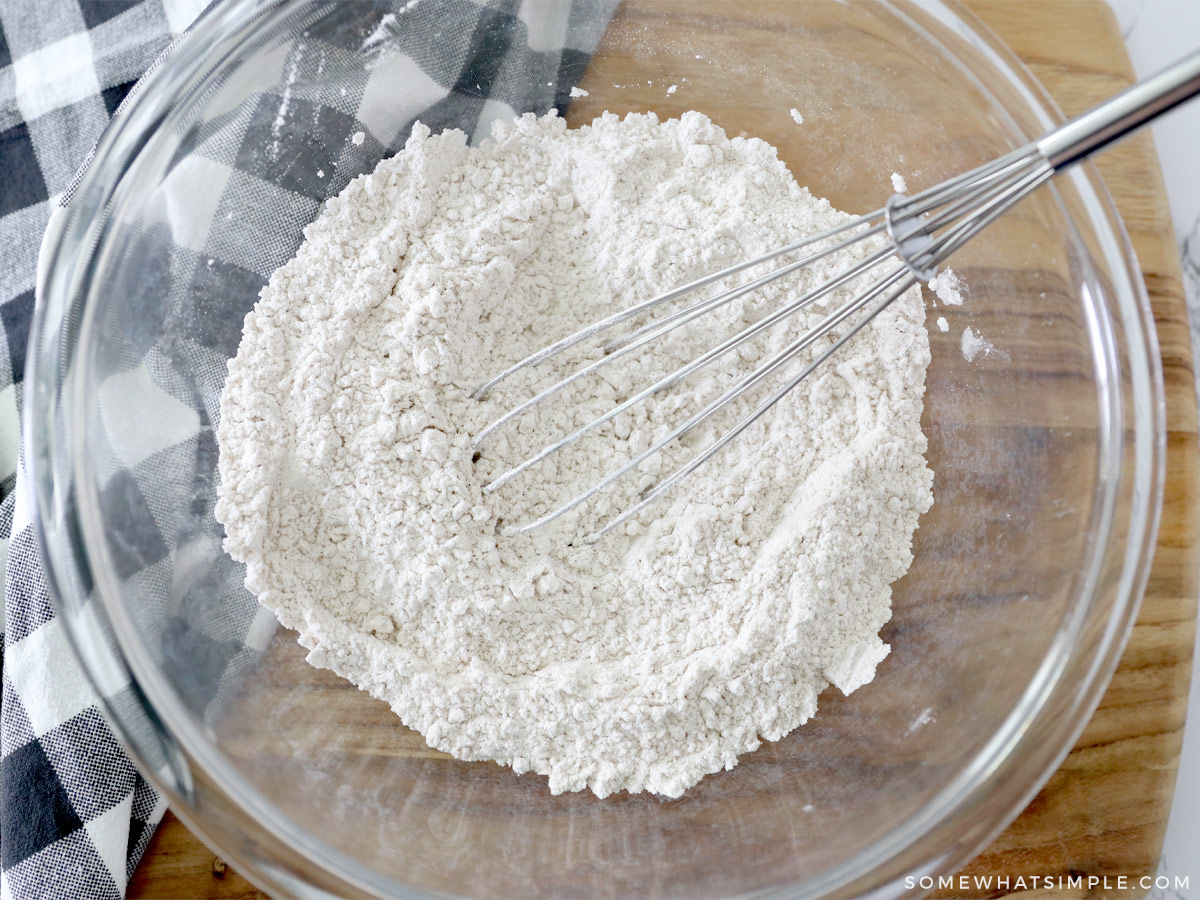 whisking flour to make pumpkin sugar cookies