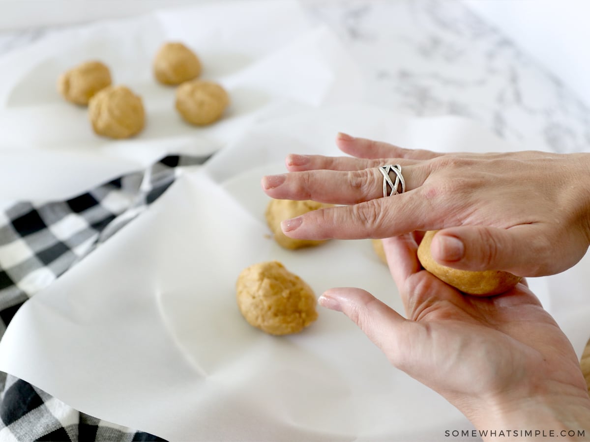 making balls of pumpkin sugar cookies