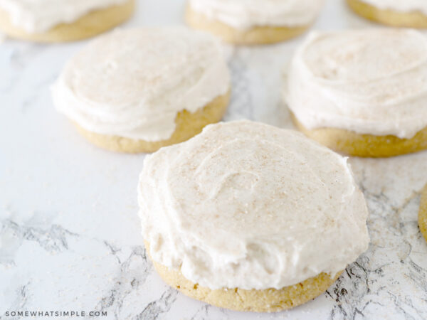 pumpkin sugar cookies frosted with cinnamon cream cheese frosting
