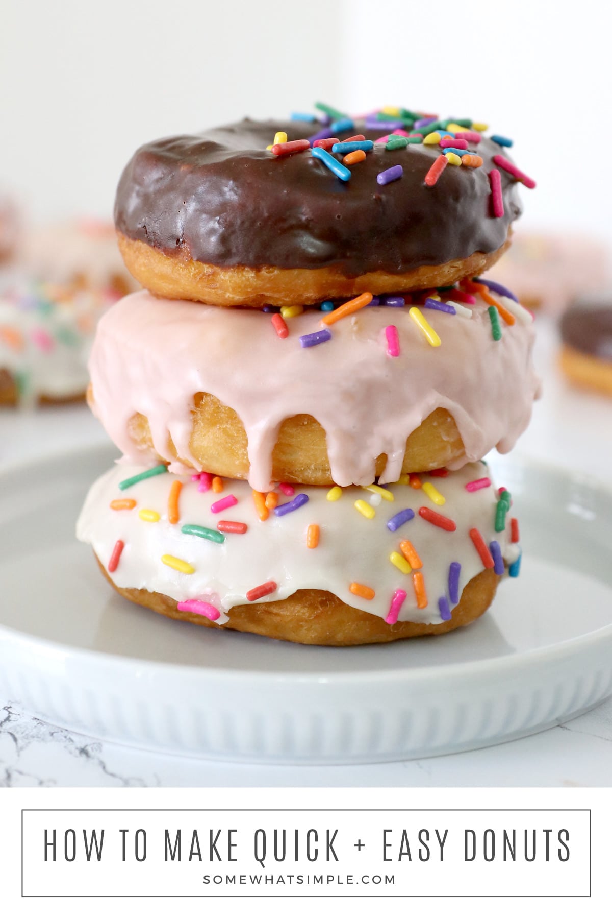 Satisfy your donut cravings with this easy 2 ingredient donut recipe! Light and fluffy biscuit donuts are drizzled with a simple glaze that will melt in your mouth! via @somewhatsimple